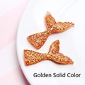 Macro detail of golden glitter resin mermaid tails with realistic scale texture for DIY - Solid Gold