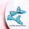 Detail of sea blue resin mermaid tails with glitter for DIY craft decorations - Solid Sea Blue