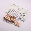 Close-up of 10-piece marble makeup brush set with gray synthetic bristles and golden ferrule - Set With Bag / 10 Piece Set / White