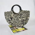 Handcrafted semicircular straw handbag with black and white spiral weave and round handles - Black and White