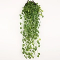Artificial hanging plant with green striped heart leaves in a brown wicker basket - Watermelon Leaf
