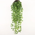 Close-up of hanging artificial ivy leaves in a brown woven basket with natural textures - Sweet Potato Leaf