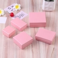 Various sizes of pink textured jewelry gift boxes displayed on a rustic wooden background - 5X5X3cm / Pink