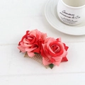Detailed view of dual velvet red rose bridal hair comb with elegant golden metal base - Watermelon red