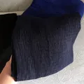 Detailed texture of dark blue pleated cotton linen scarf fabric with vertical ridges - Dark Blue