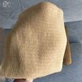 Macro detail of crinkled linen cotton fabric texture in light yellow with vertical pleats - Ginger Yellow
