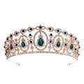 Macro view of bridal crown detailing green crystals and gold filigree on white background - Gold/Olive Green Emerald