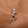 Close-up of a silver gymnast figure ear cuff on soft peach textured fabric - Silver (8989)