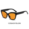 Chique cat eye zonnebril met een gepolijst zwart montuur en felle gele glazen - Zwart Frame Gele Lenzen
