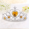 Close-up of silver princess tiara featuring a large orange heart-shaped crystal - Yellow