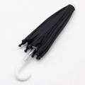 Closed black doll umbrella with white curved handle and beads on white background - Black