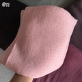 Detailed texture of pink pleated cotton linen scarf showing soft vertical fabric creases - Pink