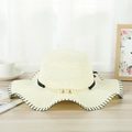 Detail of beige straw sun hat with pearl chain decoration and elegant wavy edges - Milk White