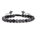 Macro view of beaded bracelet with black and spotted stones on adjustable woven cord - Snowflake Obsidian