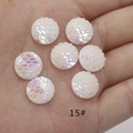 Rainbow AB resin fish scale round flatback cabochon held in hand for size display - No.15 (Bright White AB)