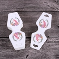Detailed view of hourglass-shaped white jewelry display cards with unicorn design - Unicorn Design