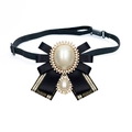 Elegant vintage black ribbon bow brooch with crystal-rimmed pearls and gold accents - Gold Black Ribbon Style