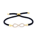 Dettaglio del bracciale infinity dorato con zirconi bianchi su cordino nero intrecciato - Cordino Nero Oro