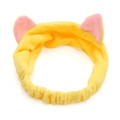 Detail of yellow plush cat ear headband with soft pink interior and elastic band design - Yellow