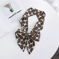 Long paisley print silk scarf tied in a bow with red and blue patterns on beige background - White Paisley