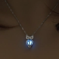 Close-up of owl pendant with glowing blue bead and intricate hollow metal texture - Sky Blue Owl