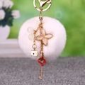 White fluffy pompom keychain with gold flower pendant and red vintage key charm - Clover Key + White Pom Pom