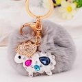 Gray pom pom keychain featuring a gold-plated sheep pendant with colorful rhinestones - White Lamb + Grey Pom Pom