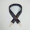 Detail of adjustable ethnic style bag strap with floral pattern and gold metal hardware - Peacock