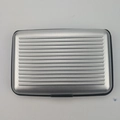 Waterproof aluminum card holder in silver gray with ribbed texture and secure buckle - Silver