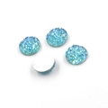 Macro shot of 8mm blue druzy resin cabs showing textured sparkle and flat white backings - Blue Glitter (18)