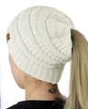 Detail view of cream knit beanie featuring functional ponytail hole for long hair - White