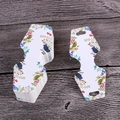 Macro shot of paper earring display cards featuring watercolor floral and bird patterns - Colorful Tree Branches