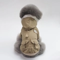 Detail view of khaki dog winter coat featuring a grey faux fur collar and functional cargo pockets - Khaki