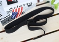 Detail of black canvas tactical belt with durable plastic buckle on a wooden background - One Size / Black