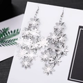 Silver flower tassel drop earrings with hollow petals hanging on a white display board - E1497-2 Hollow Flower