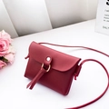 Mini dark red faux leather crossbody bag with gold ring and tassel detail - Burgundy