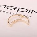 Macro view of a gold-tone crescent moon hair clip with a classic metal spring fastener - Moon Gold