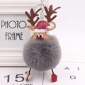 Detailed view of Christmas reindeer plush keychain with grey pompom and red boots - Dark Gray