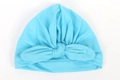 Detail of baby turban hat in light blue with a decorative front knot on white background - Lake Blue