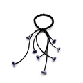 Detail of black spiral hair tie with dangling light purple flower pendants on white background - Black-Purple