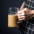 Hand holding a 500ml heat-resistant borosilicate glass measuring cup with handle - 500ml Single Cup (No Lid)