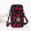 Mini crossbody phone bag in black canvas featuring a pink lip print and adjustable strap - Lip Gloss