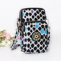 Stylish vertical crossbody phone bag with black and white leopard print and purple accents - Black with White Polka Dots