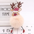 Detailed view of plush reindeer pompom keychain with a festive red Santa hat and metal ring - Nude Pink