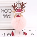 Detail of pink plush Christmas reindeer keychain with festive hat and silver metal ring - Pink