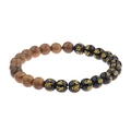 Close-up of wooden and black beads with golden engraved symbols on a stretch bracelet - ABJ005-G Sanskrit Mantra & Wood