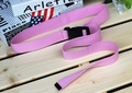 Pink canvas belt with black plastic buckle detail shown on a light wooden background - One Size / Pink