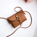 Mini brown faux leather crossbody bag with golden ring detail and slim shoulder strap - Brown