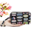 Women's long fabric wallet in black with colorful cartoon labels and a wrist strap - Romantic Labels Print