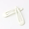 Set of two white glossy metal snap clips for hair styled in a cross on white background - Milky White